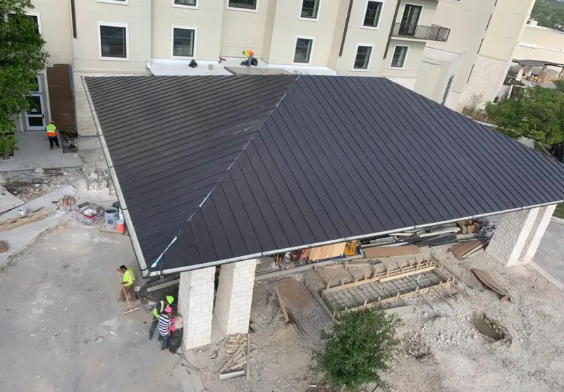 Metal roofing installation team working on a commercial building in Fairland